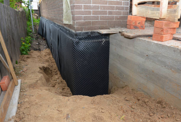 SJ Waterproofing Pros technician performing targeted Wet Basement Repair assessment in Kiel, WI